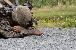 U.S. Marine Corps Lance Cpl. Ian Acosta probes for a mine on a clearance patrol during a field exercise (FEX) at Marine Corps Training Area Bellows, Waimanalo, Hawaii.