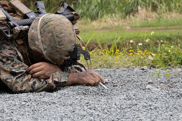 U.S. Marine Corps Lance Cpl. Ian Acosta probes for a mine on a clearance patrol during a field exercise (FEX) at Marine Corps Training Area Bellows, Waimanalo, Hawaii.