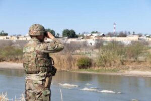 Soldier surveys an area that is popular for border crossing near Laredo