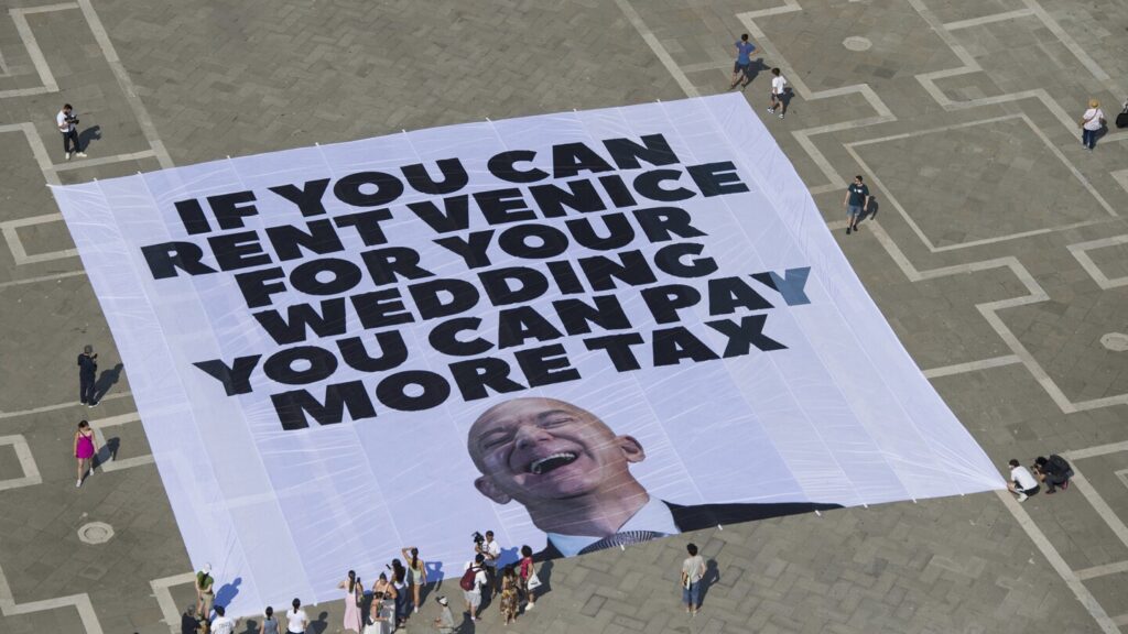 Life-size mannequin of Jeff Bezos lying on a giant Amazon box dropped into Venice's Grand Canal