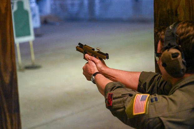 U.S. Air Force airman fires a M18 pistol