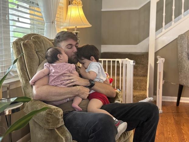 U.S. Marine Corps veteran Adrian Clouatre holds his 3-month-old daughter