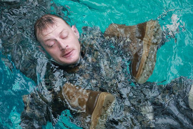 U.S. Marine utilizes his boots and trousers as a flotation device