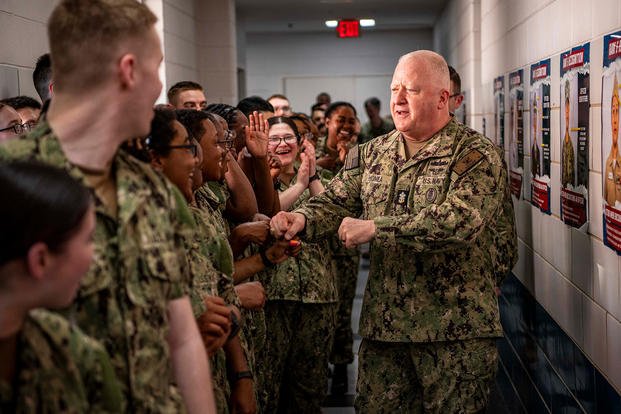 Master Chief Petty Officer of the Navy James Honea congratulates recruits