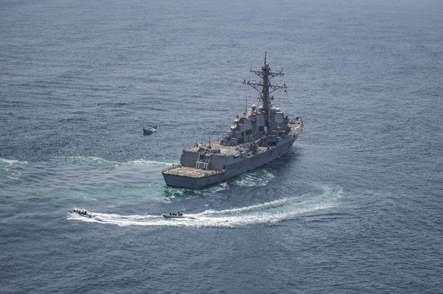 USS Jason Dunham approaches a skiff