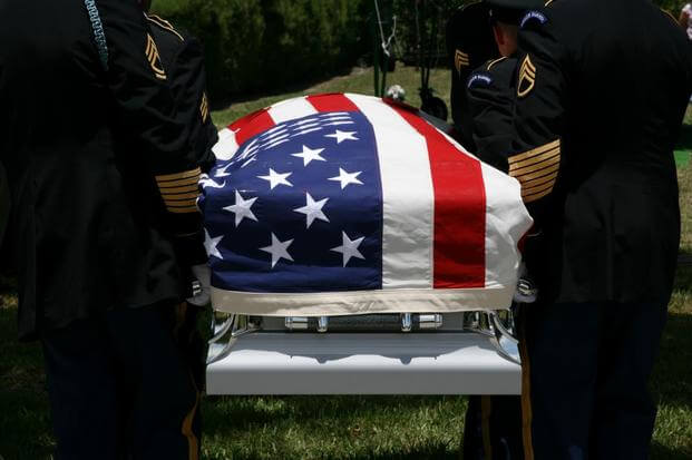 coffin with U.S. flag draped on top of it