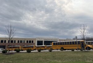 School buses parked outside Hammond High School in Columbia, Md., a suburb of Baltimore. Students ages 12 to 18 experienced higher rates of reported victimization at school than away from school in 2024, according to a new report from the federal Bureau of Justice Statistics. (Photo by Amanda Watford/Stateline)