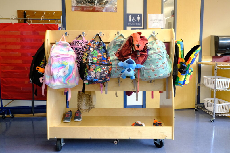Student backpacks hang in their cubbies at a school in Alaska. At least 30 states have opted into a federal program allowing individuals to receive tax credits for donations to scholarship organizations that might offer tuition help for private schools or extra tutoring. (Photo by Corinne Smith/Alaska Beacon)